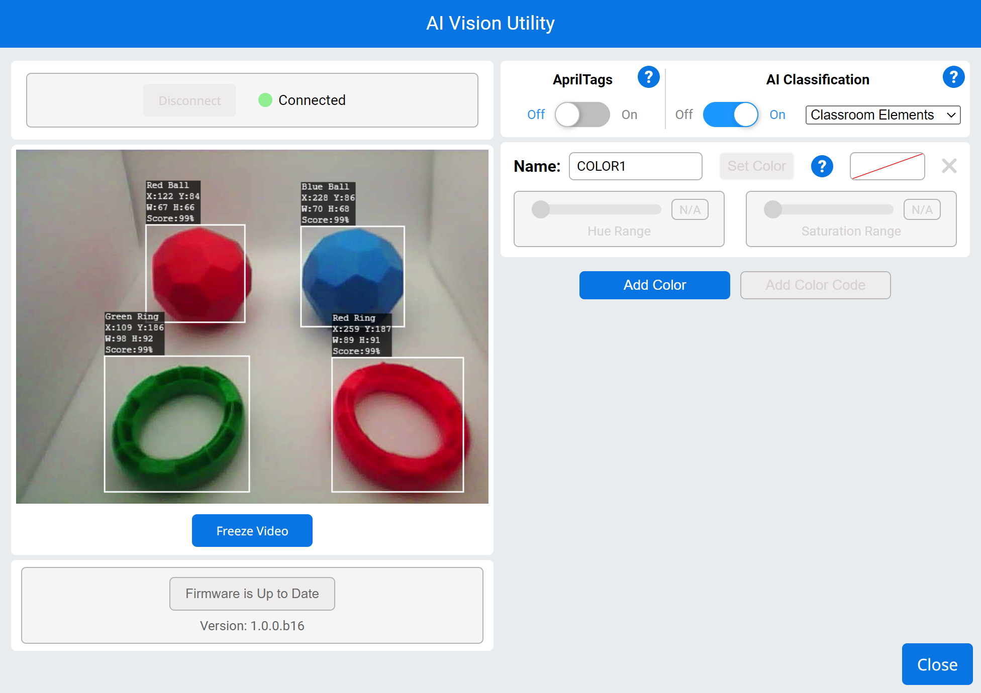 Screenshot dell'interfaccia di 'AI Vision Utility'. L'interfaccia è connessa, come indicato dallo stato verde "Connesso". La sezione principale mostra un feed di una telecamera in diretta con quattro oggetti rilevati: una palla rossa, una palla blu, un anello verde e un anello rosso, ciascuno con riquadri di delimitazione che mostrano le rispettive posizioni (X, Y), dimensioni (L, A) e punteggi di affidabilità (99%). Il pannello di destra contiene le opzioni per abilitare AprilTags e la classificazione AI, con la classificazione AI impostata su "Elementi della classe". C'è un'opzione per assegnare un nome e impostare un colore, con pulsanti per "Aggiungi colore" e un pulsante "Blocca video" sotto il feed live. Lo stato del firmware è indicato come "Aggiornato" con versione "1.0.0.b16".
