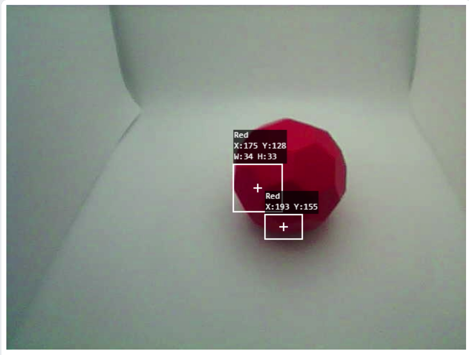 Nguồn cấp dữ liệu video của AI Vision Utility được hiển thị và một Buckyball màu đỏ nằm trong tầm nhìn của cảm biến. Chỉ có hai vùng nhỏ của Buckyball được cảm biến làm nổi bật, cho biết phạm vi Sắc độ và Độ bão hòa không chính xác và cần phải tăng lên.