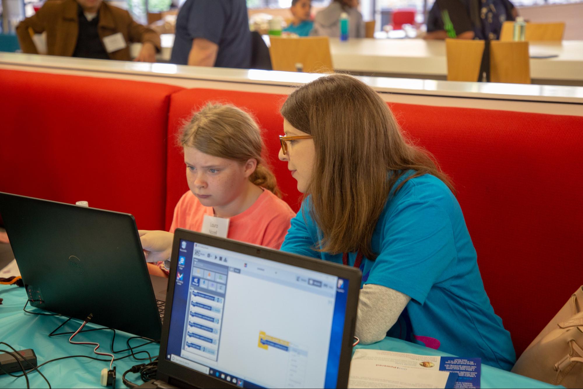 Student en mentor kijken naar laptop