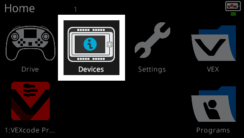 The Home screen of the VEX V5 Brain interface showing six icons. The Devices icon in the top center is highlighted with a white border, indicating it is selected. Other visible icons include Drive, Settings, VEX, VEXcode Pro, and Programs.