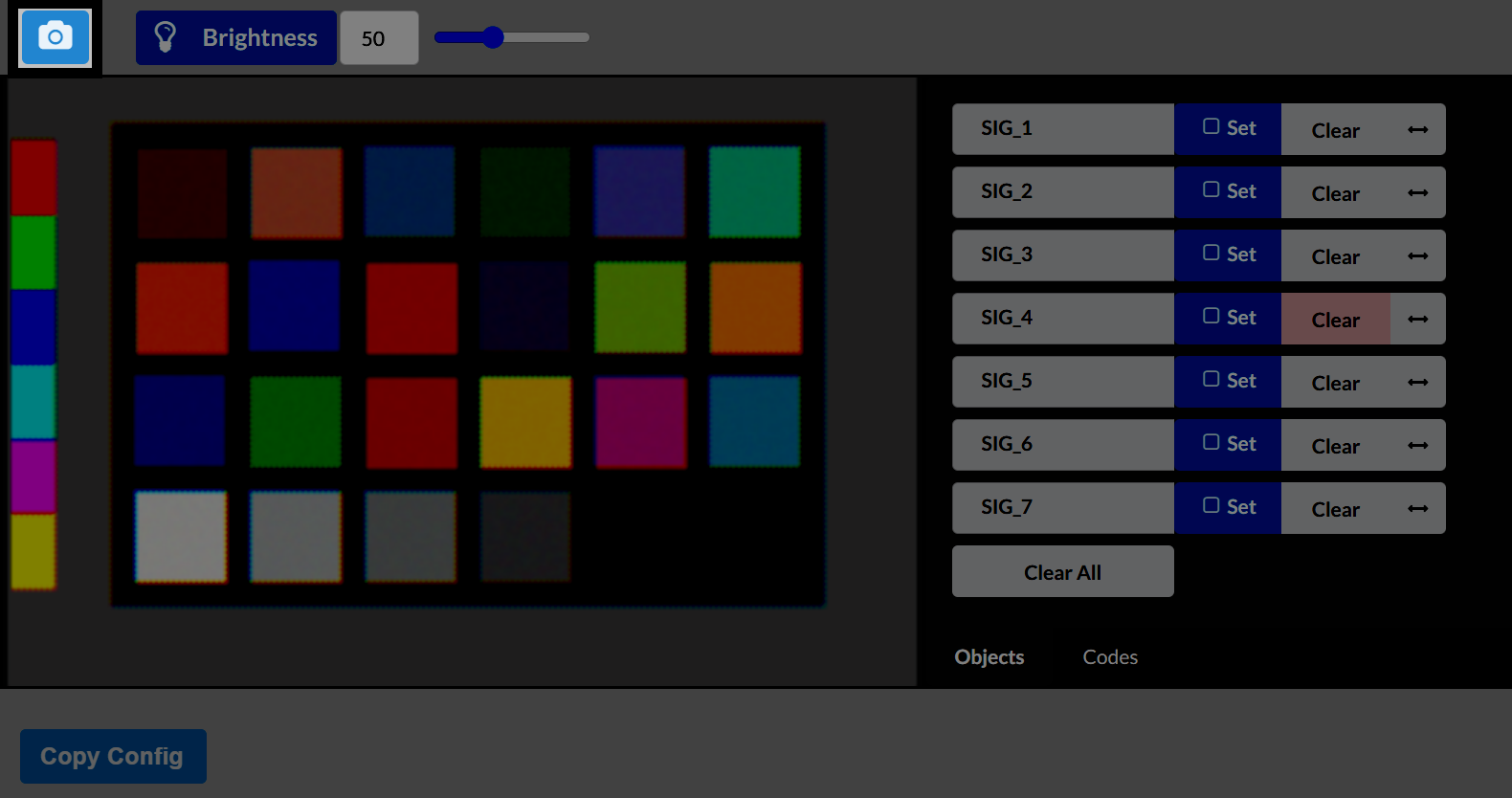 The Vision Sensor Utility interface shows a grid of colorful calibration squares on the left and a list of Signature slots on the right, labeled SIG_1 through SIG_7. Each signature has buttons for Set and Clear. The brightness slider at the top is set to 50. A Copy Config button appears at the bottom.
