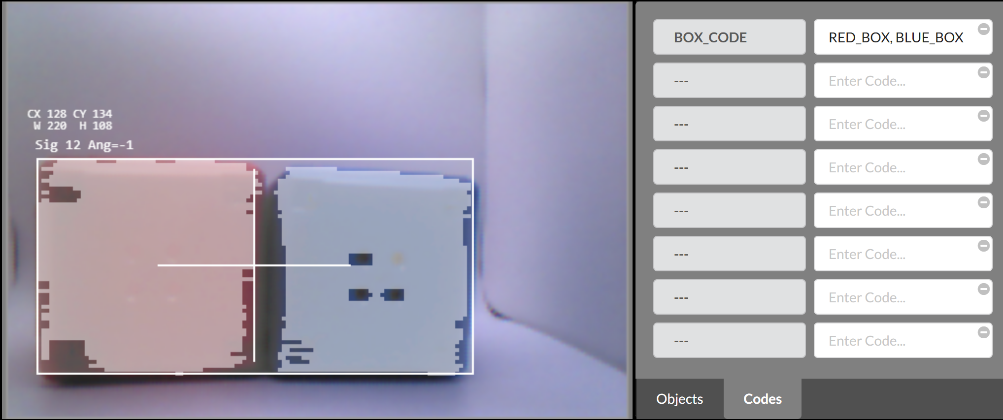 The Vision Sensor preview shows a single large white bounding box combining both the red and blue cubes. The text at the top reads CX 128, CY 134, width 220, height 108, Sig 12 Ang=-1, indicating the combined object signature. The Codes panel on the right shows BOX_CODE as the identifier, with RED_BOX and BLUE_BOX listed as component elements.