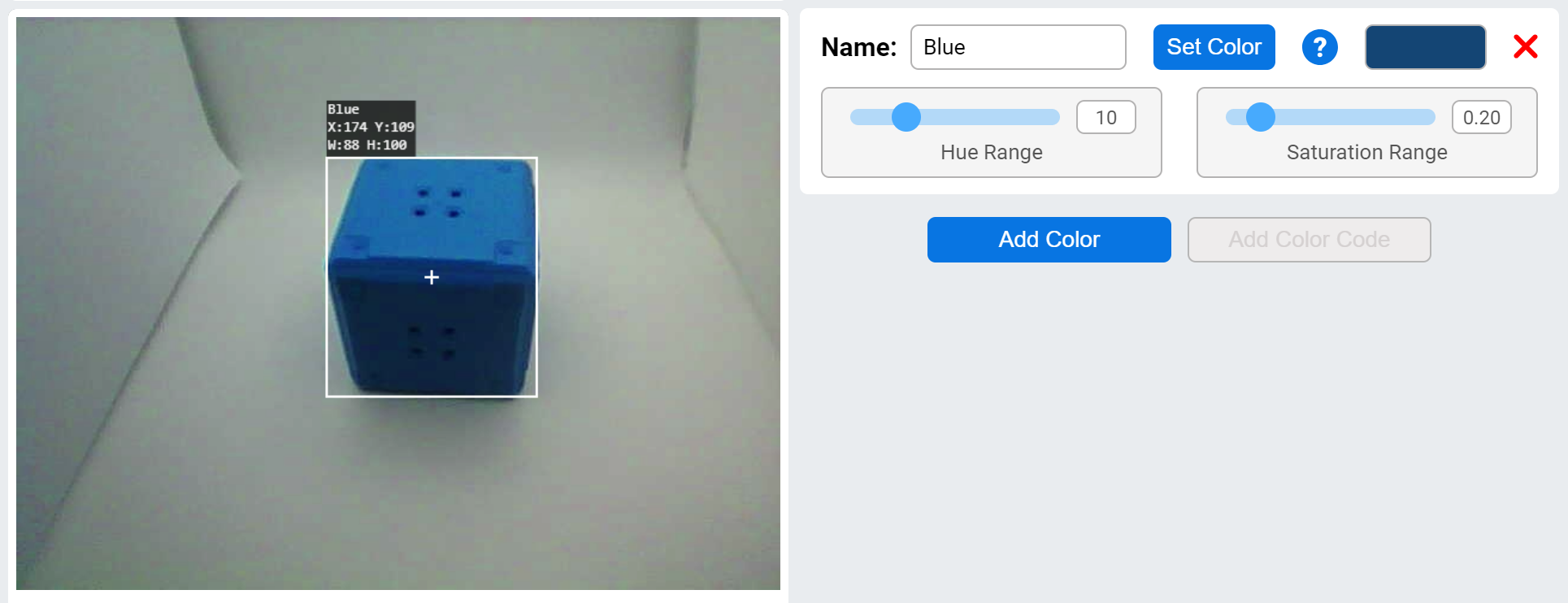An AI Vision utility interface where a blue cube is being tracked. The left side displays the cube with coordinates X:174, Y:109, and dimensions W:88, H:100. On the right side, the color settings are labeled as Blue, with a hue range set to 10 and saturation range set to 0.20. There is a Set Color button and a color swatch showing the selected shade of blue. Below that is an option to add the color and a disabled button labeled Add Color Code.