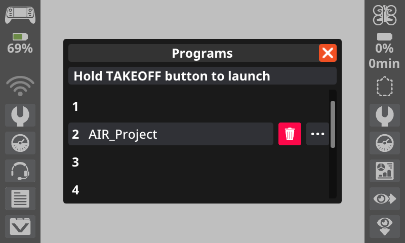 VEX AIR controller screen showing Programs menu with four numbered slots, Slot 2 containing AIR_Project, and a message reading Hold TAKEOFF button to launch; delete icon is shown next to the project