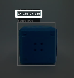 Close up of a Blue Cube being detected by the AI Vision in the Utility. A highlight calls out a portion of the text above the Blue Cube that reads C X colon 169 C Y colon 139. This indicates that the center coordinate of the cube is 169, 139.