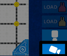 A close-up screenshot of the buttons in the lower right corner of the Playground Window with the chase camera button, showing a white camera icon angled downward to the right, highlighted below the top camera button.