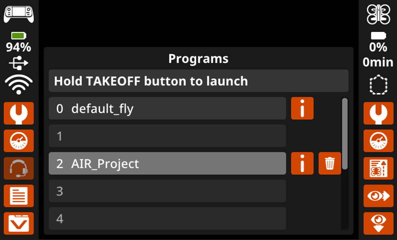 Pantalla DEL controlador de AIRE VEX que muestra el menú Programas con cuatro ranuras numeradas, la ranura 2 que contiene AIR_Project y un mensaje que dice Mantener pulsado el botón de DESPEGUE para iniciar; el icono de eliminación se muestra junto al proyecto