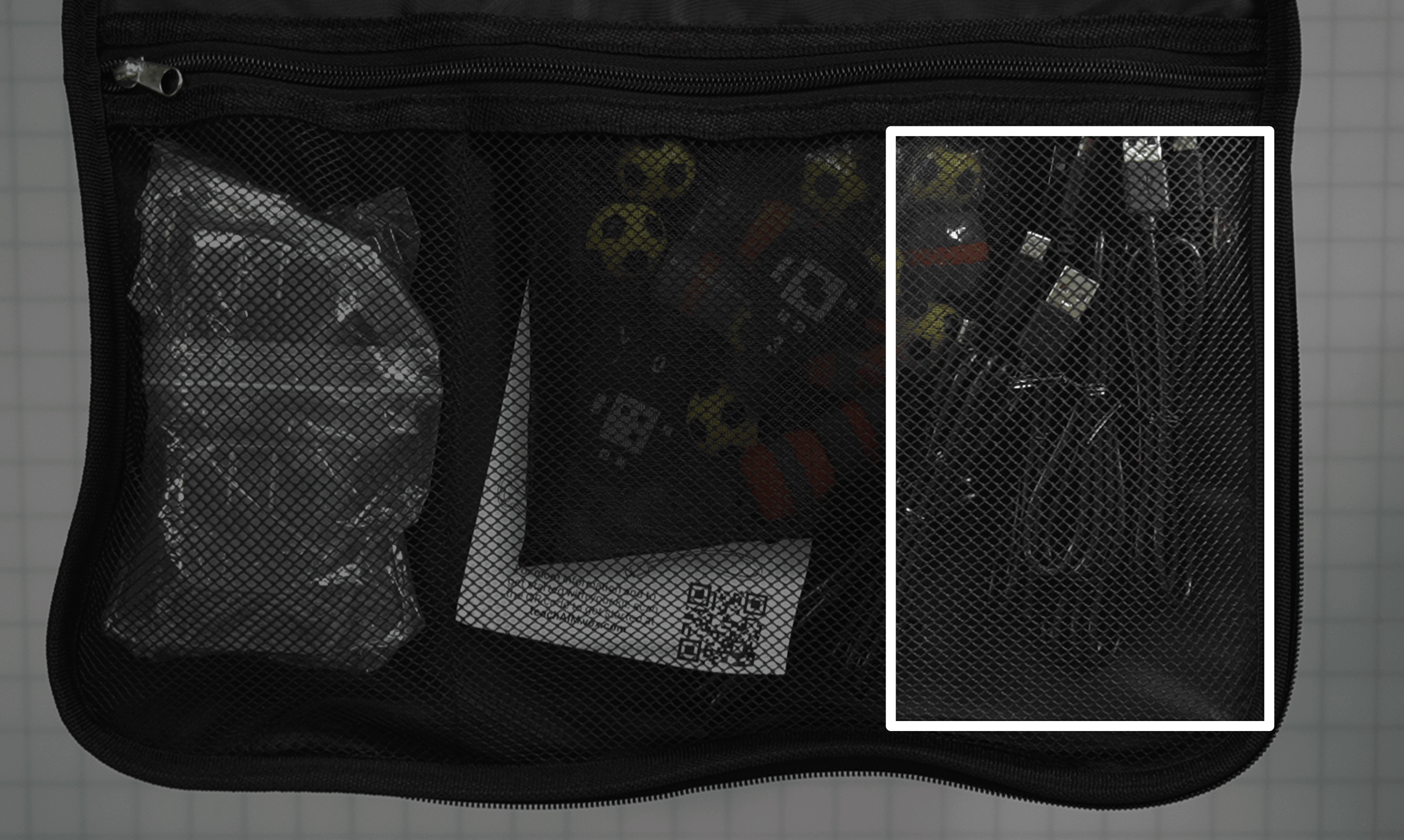 The same image as the one previously in this column, with six USB cables wound individually to the far right of the large side of the zippered pocket.