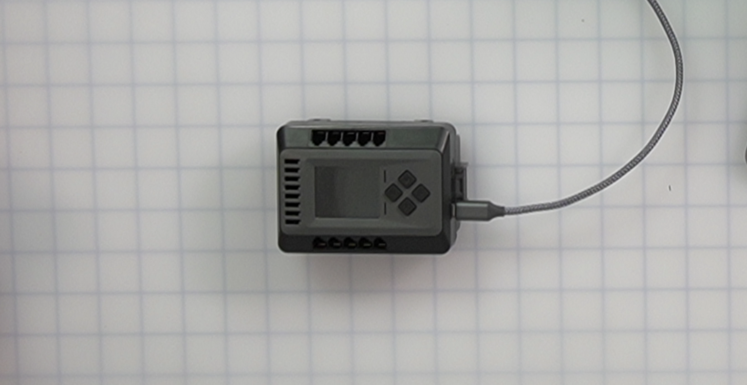 EXP Brain with an attached USB cable.