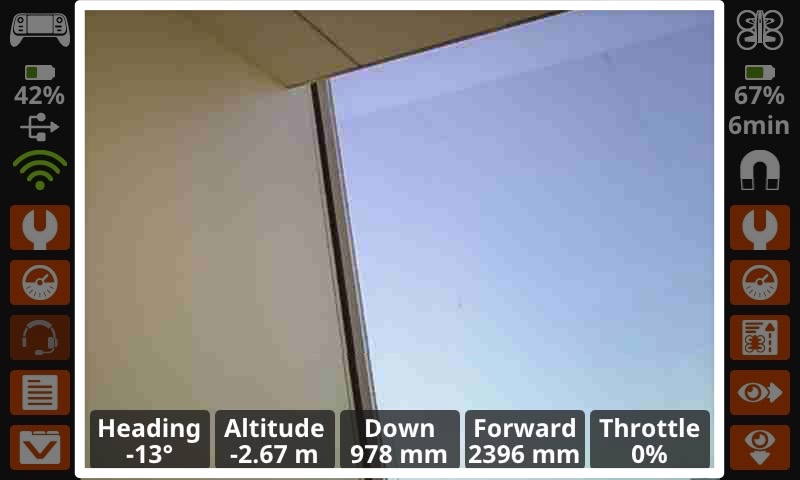 Screen of the Controller is shown, with the center of the screen, showing the view from the forward facing camera, highlighted, between two columns of buttons.