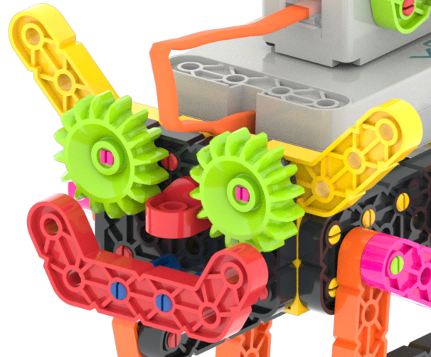 Primer plano de la cara en una construcción VEX GO Crawler, donde las piezas Green Gear se utilizan como ojos decorativos en la cara del robot.