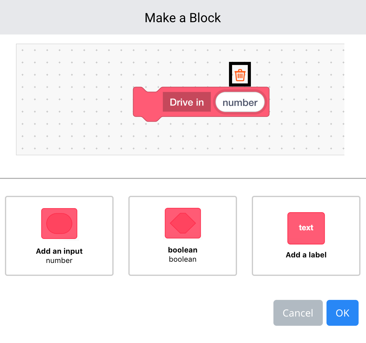 قائمة VEXcode GO Make a Block مفتوحة وتم تعيين اسم الكتلة على Drive in. تمت إضافة حقل إدخال رقم إلى الكتلة، وتم تسليط الضوء على أيقونة المسح الموجودة أعلى الحقل.