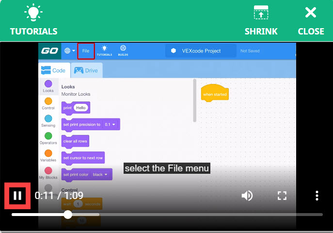 El video tutorial de uso de ejemplos está abierto y se está reproduciendo, y el ícono de pausa de video en la parte inferior izquierda está resaltado.