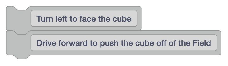 Deux blocs de commentaires indiquant Tournez à gauche pour faire face au cube, puis Avancez pour pousser le cube hors du terrain.