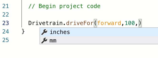VEXcode IQ C++ -työtila, jossa on ehdotettujen komentojen alasvetovalikko. Komento Drivetrain.driveFor(forward,100,) on kirjoitettu tyhjällä viimeisellä parametrilla, ja funktion kyseisen osan parametrit ovat saatavilla valikosta. Ensimmäinen parametrivaihtoehto lukee tuumaa.