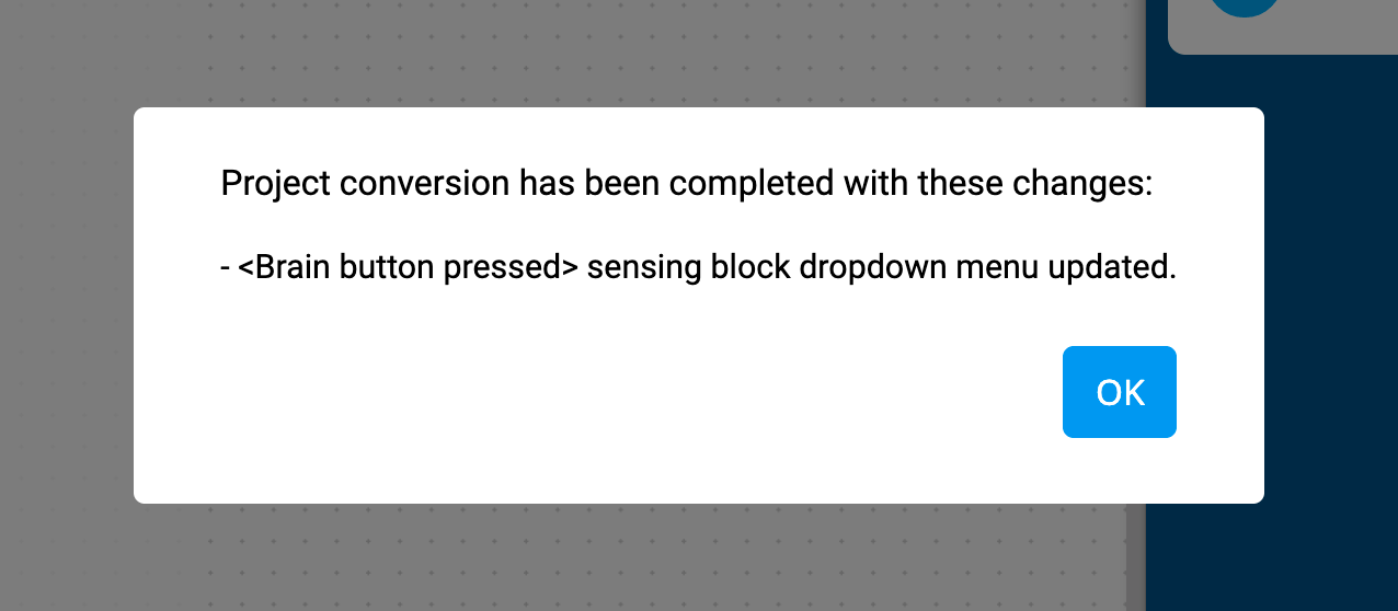 El indicador de conversión de proyecto VEXcode IQ que dice Conversión de proyecto se ha completado con estos cambios. Botón Cerebral Se ha actualizado el menú desplegable del bloque de detección pulsado. Hay un botón OK a continuación.