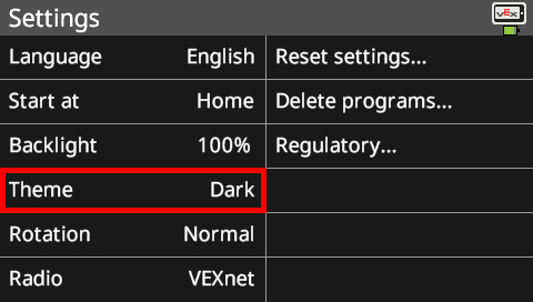 Brain screen is shown in the Settings menu with the Theme option highlighted. This menu has many options that can be customized. The options in this screenshot read Language English, Start at Home, Backlight 100%, Theme Dark, Rotation Normal, and Radio VEXnet. There are also system options on the right that read Reset settings, Delete programs, and Regulatory.