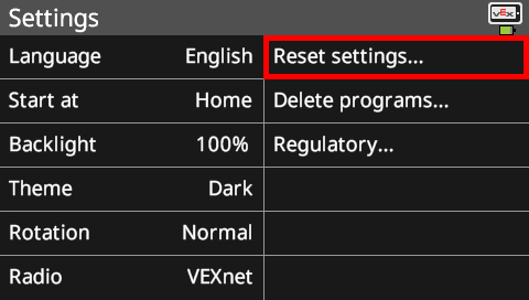 Brain screen is shown in the Settings menu with the Reset settings option highlighted. This menu has many options that can be customized. The options in this screenshot read Language English, Start at Home, Backlight 100%, Theme Dark, Rotation Normal, and Radio VEXnet. There are also system options on the right that read Reset settings, Delete programs, and Regulatory.