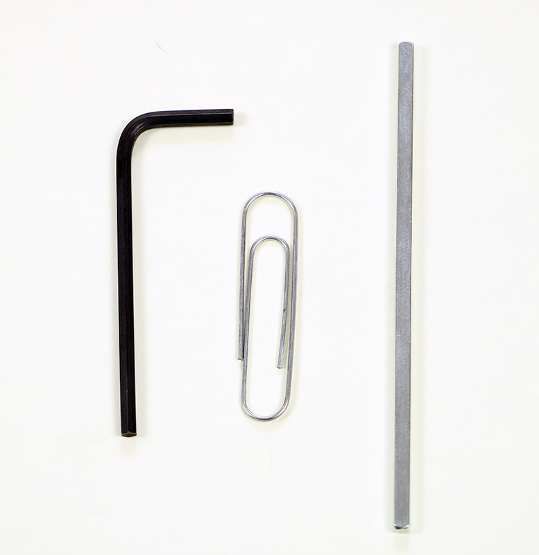 Tools that could be used to reset the Controller are shown together. In this example, there is a hex key, a VEX shaft piece, and a paper clip.
