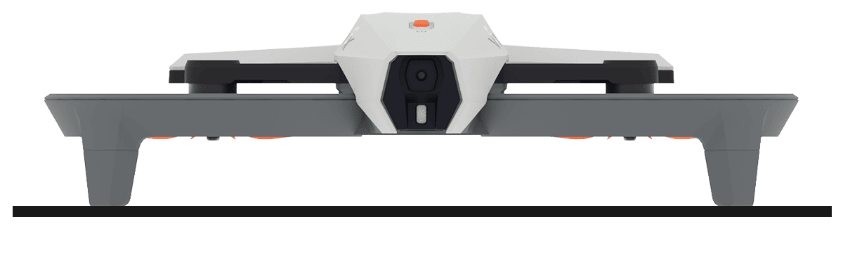 Tampak depan drone yang diletakkan di atas permukaan datar sehingga drone tersebut rata dan keempat kaki pendaratannya stabil di tanah.