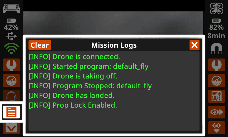 Der Controller-Bildschirm zeigt rechts eine Schaltfläche mit dem Listensymbol „Mission Logs“, auf der die Liste angezeigt wird. In der Mitte des Bildschirms ist das Fenster „Mission Logs“ sichtbar. In der oberen linken Ecke des Fensters befindet sich eine Schaltfläche „Löschen“, und in der oberen rechten Ecke eine Schaltfläche „x“.