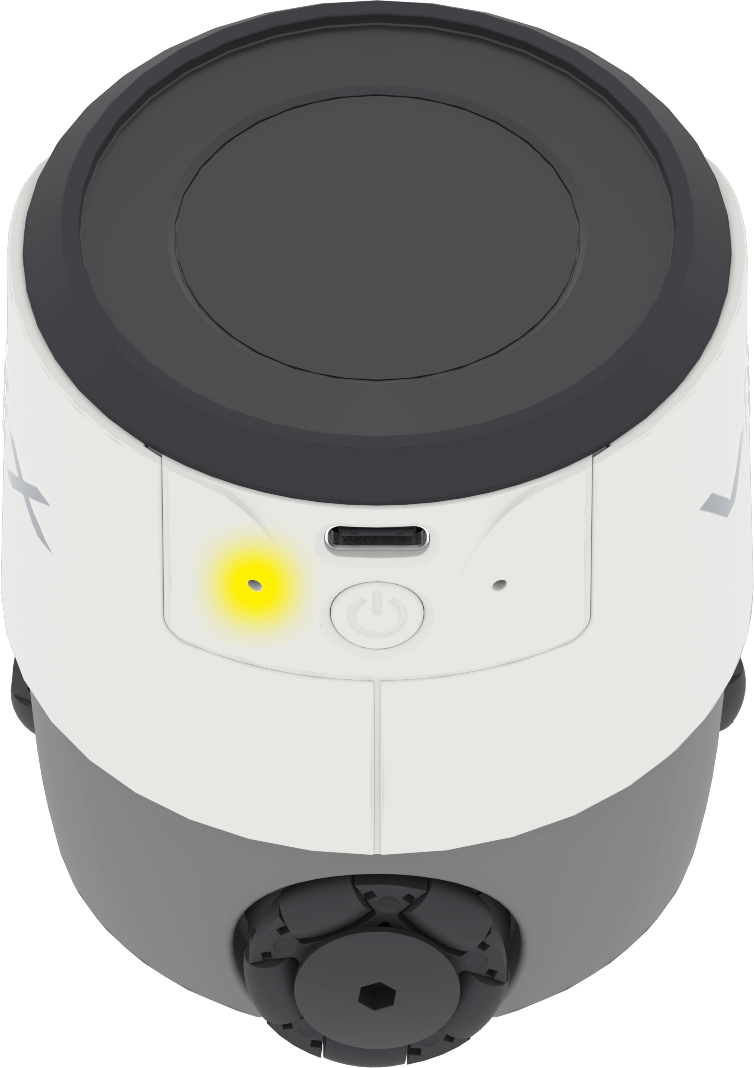 Een VEX AIM-coderingsrobot, van achteren gezien, met een gloeiend geel lampje aan de linkerkant, vlak bij de USB-C-poort, waarop de locatie van de resetknop is aangegeven.