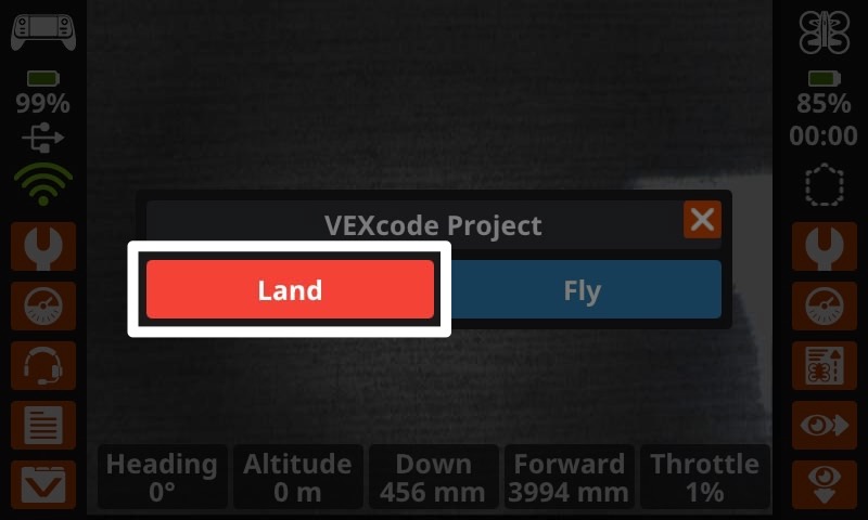 Tangkapan layar perintah pada layar Controller, menunjukkan nama proyek di bagian atas dengan dua pilihan tombol - di sebelah kiri tertulis Land (Mendarat) dan di sebelah kanan tertulis Fly (Terbang). Tombol Tanah disorot yang menunjukkan apa yang harus dipilih untuk menghentikan proyek.