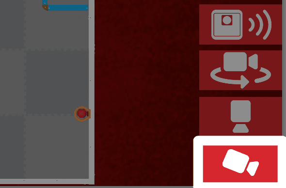 Gambar yang sama seperti sebelumnya, dengan tombol kamera kejar, ikon kamera putih menunjuk secara diagonal ke kanan bawah, disorot di bawah kamera atas.