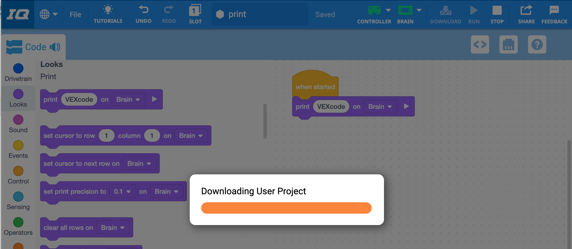 VEXcode IQ Downloading User Project prompt with a progress bar that indicates it is still downloading.