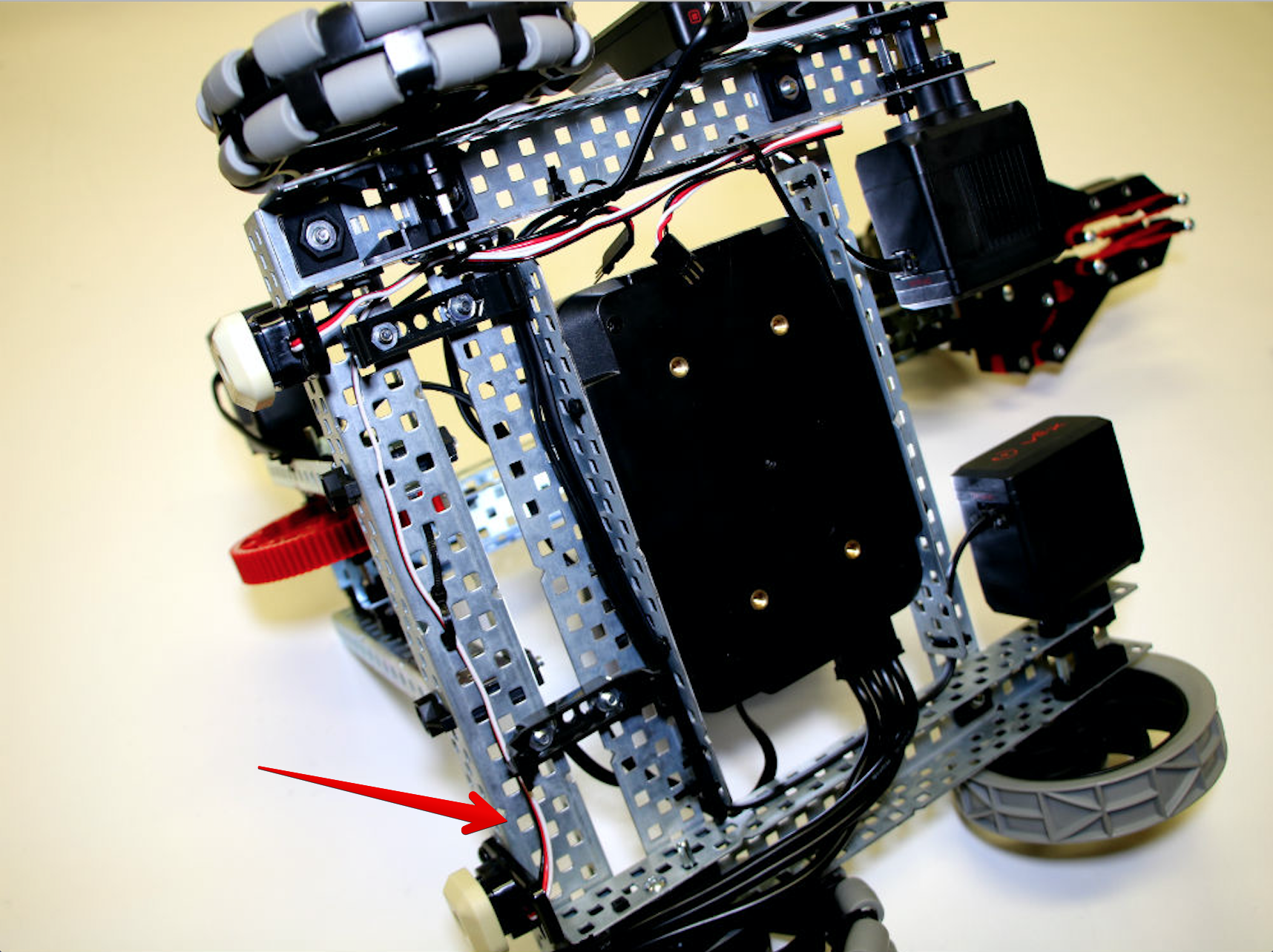 View of the robot from the bottom to show the path that the wire from the left Bumper Switch is taking. This wire travels along the bottom of the robot near the Battery Clips.
