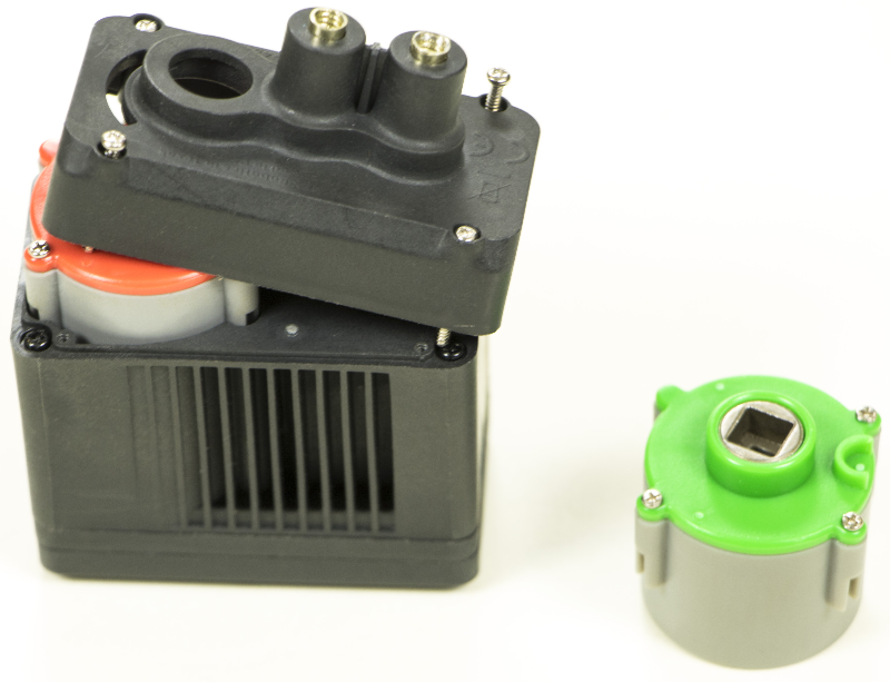 V5 Smart Motor with its cap unscrewed and raised to show the current Gear Cartridge underneath. In the example, the Gear Cartridge is orange and will be replaced with a green Gear Cartridge.
