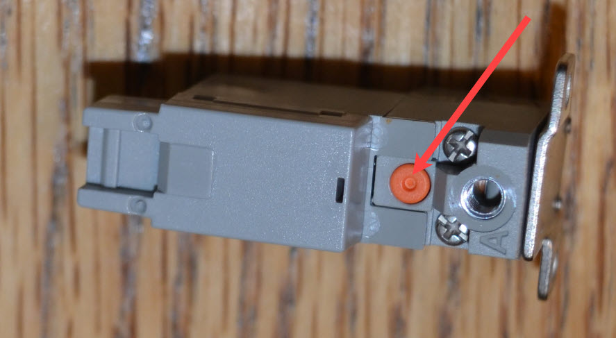 Small orange circular button on the top of the valve is highlighted.