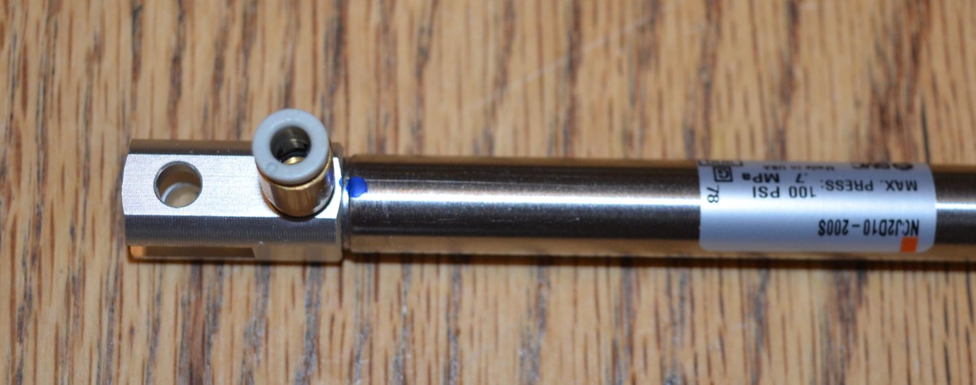 Single Acting Cylinder is shown with a Fitting attached to one of its ports.