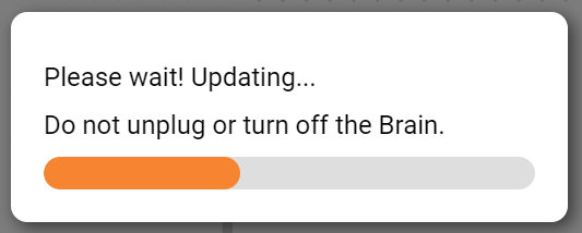 VEXcode V5 Updating prompt with a progress bar and a message that reads Please wait! Updating, do not unplug or turn off the Brain.