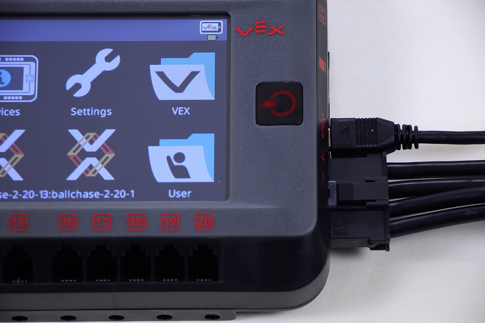 Close up of the connection ports on the V5 Brain, with a Micro-USB cable and a V5 Battery Cable currently connected.