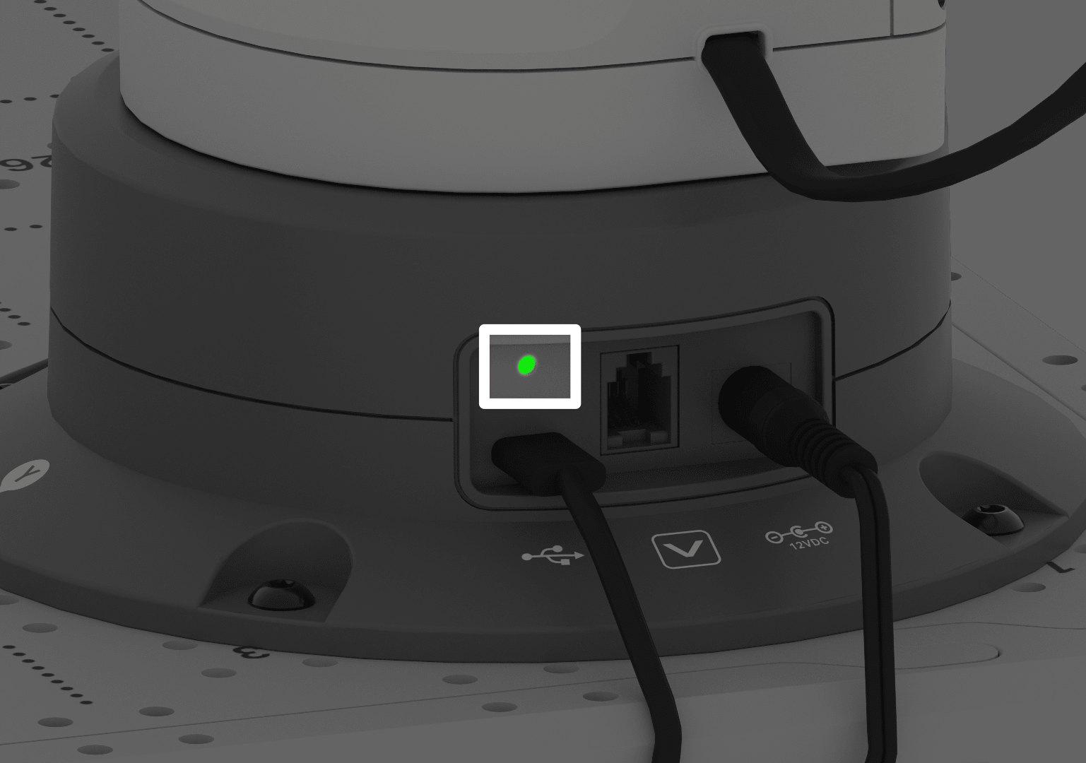 The back of the 6-Axis Arm showing the USB-C cable plugged into the left side port, the center Smart Port is empty, and the power cable is plugged into the far right port. A green indicator light glows to show connection.