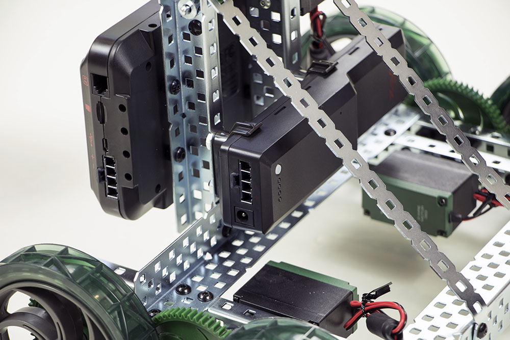 The battery inserted into the battery clips on the clawbot.