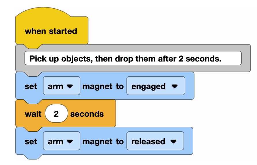 VEXcode EXP Blocks project that reads When started, then a comment reading Pick up objects, then drop them after 2 seconds, followed by set arm magnet to engaged, wait 2 seconds, set arm magnet to released.