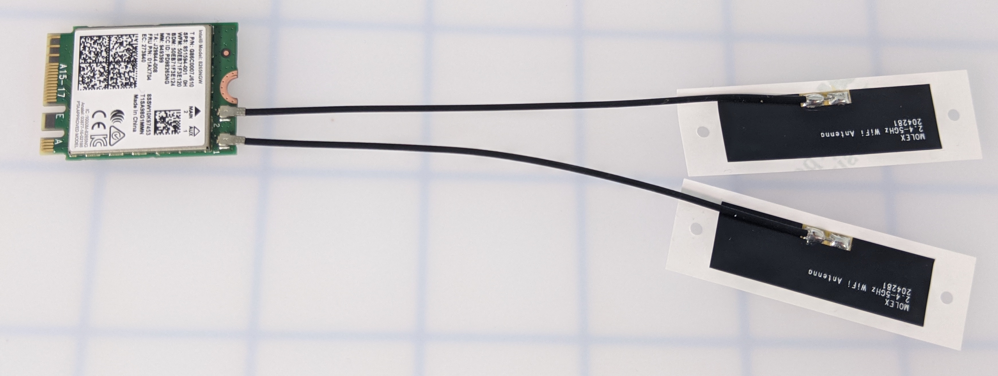 Wi-Fi module with both antennas attached and cables extending outward.