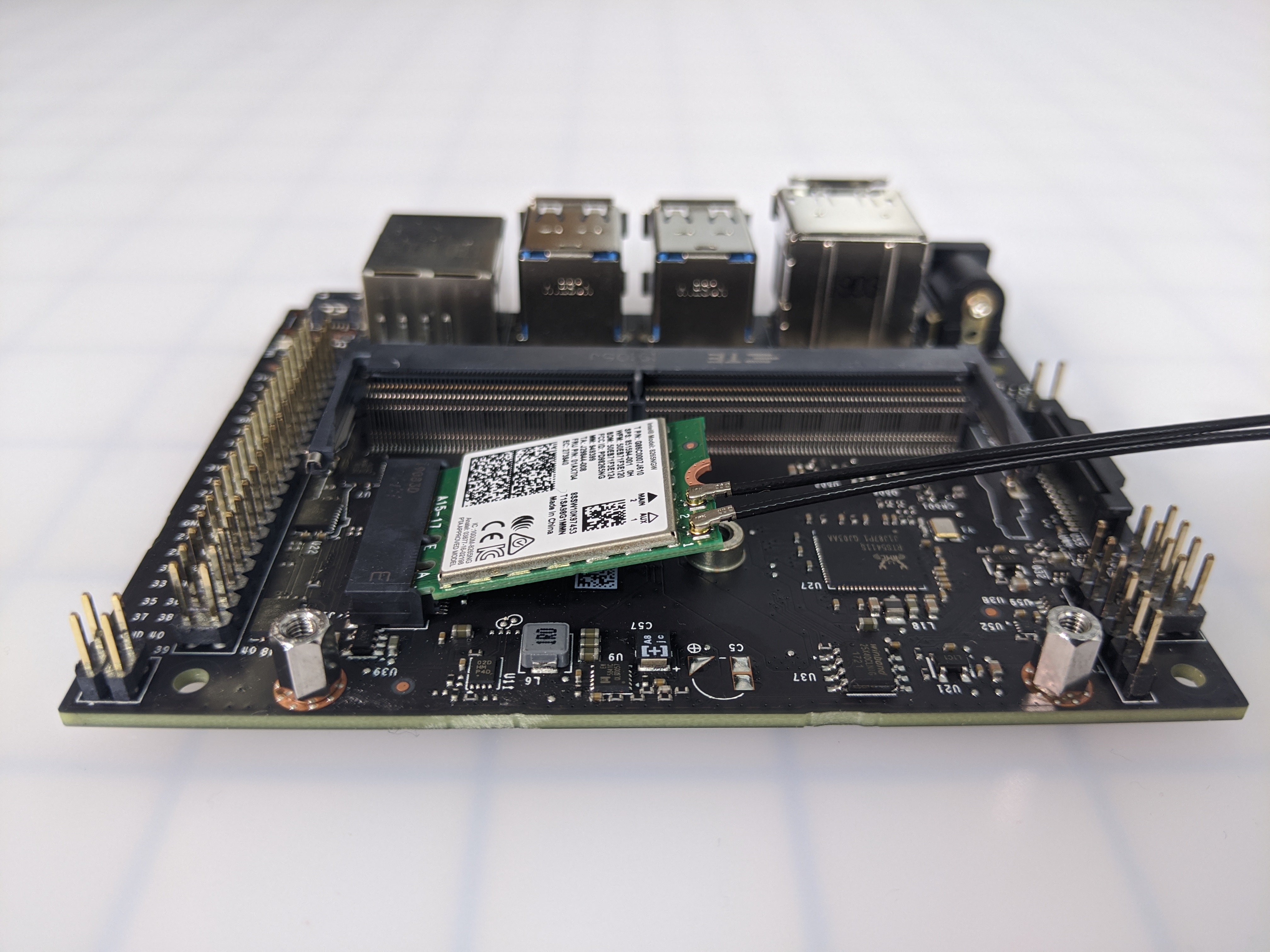 Wi-Fi module seated in the carrier board but angled upward before being secured with a screw.