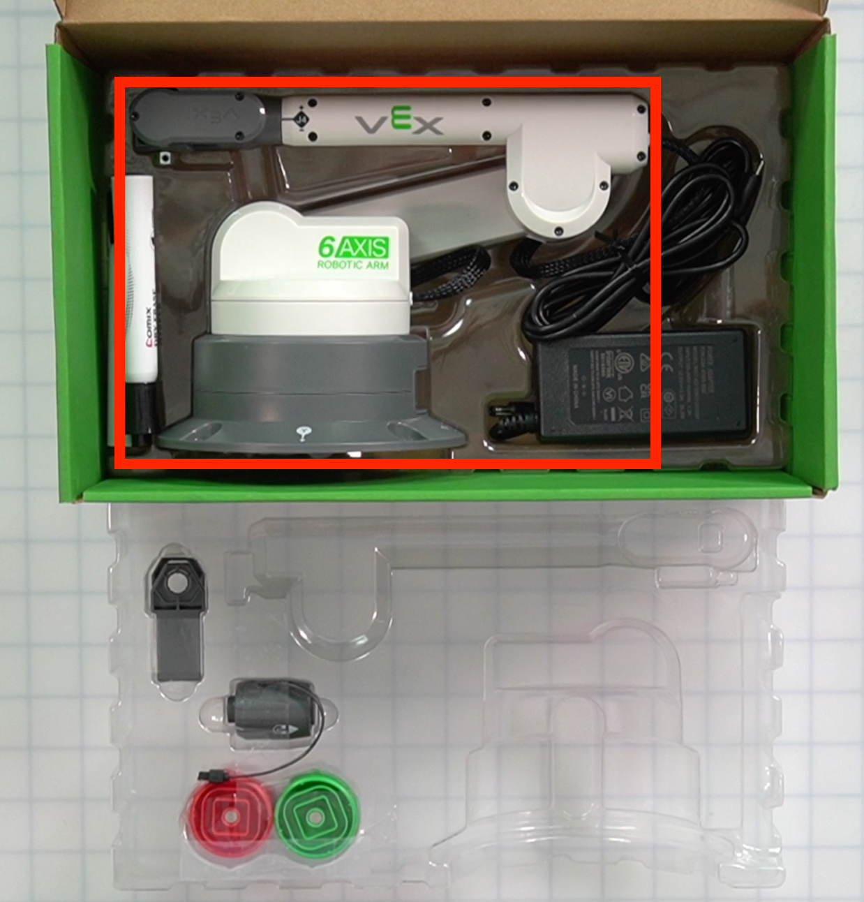 Kit box with the plastic tray removed and the arm position highlighted in the center of the box.
