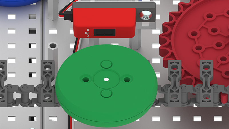 Close-up of conveyor area showing line tracker sensor detecting a colored disk.