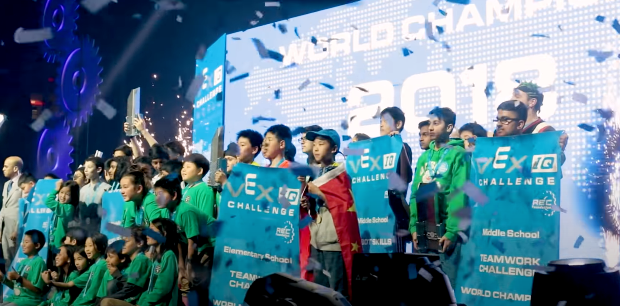 Winning teams of the VEX Robotics World Championship on stage with confetti falling.