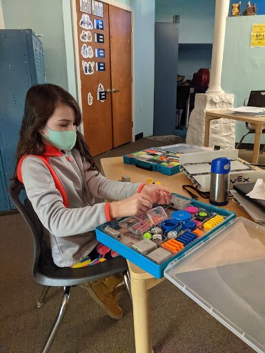 A female student using VEX GO kits for hybrid learning activities