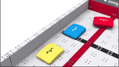 A close up of the Red Floor Goal showing a yellow bean bag scored, and a blue and red bean bag that are not scored.